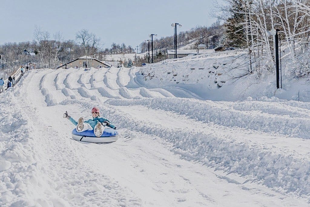 Beech Mountain Resort Snow Tubing Snow Tubing Slopes at Beech Mountain Resort, with a tuber silding down.