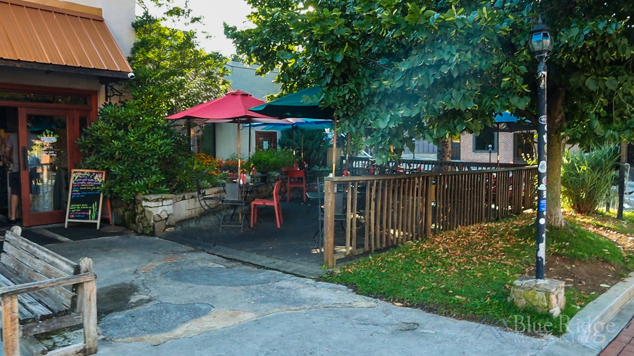 Melanie's in Boone NC Entrance to Melanie's in Boone NC showing the main building and front fenced in patio under the large trees out front.