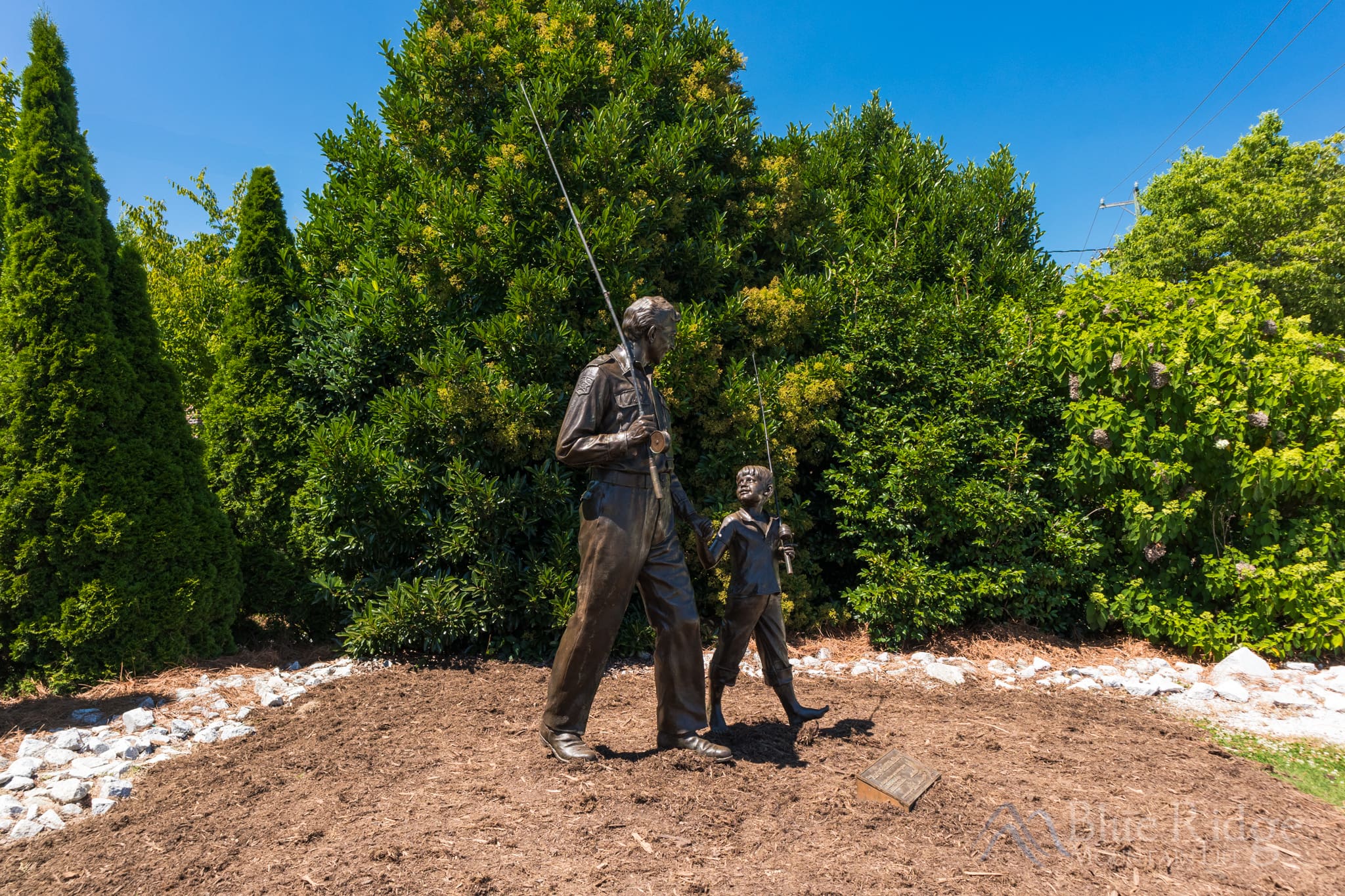 Andy Griffith Museum in Mount Airy North Carolina Photo of the statue of Sheriff Andy Taylor and his son opie, out in front of the Andy Griffith Museum. Andy is holding a fishing pole like from the opening scene of TV Show.