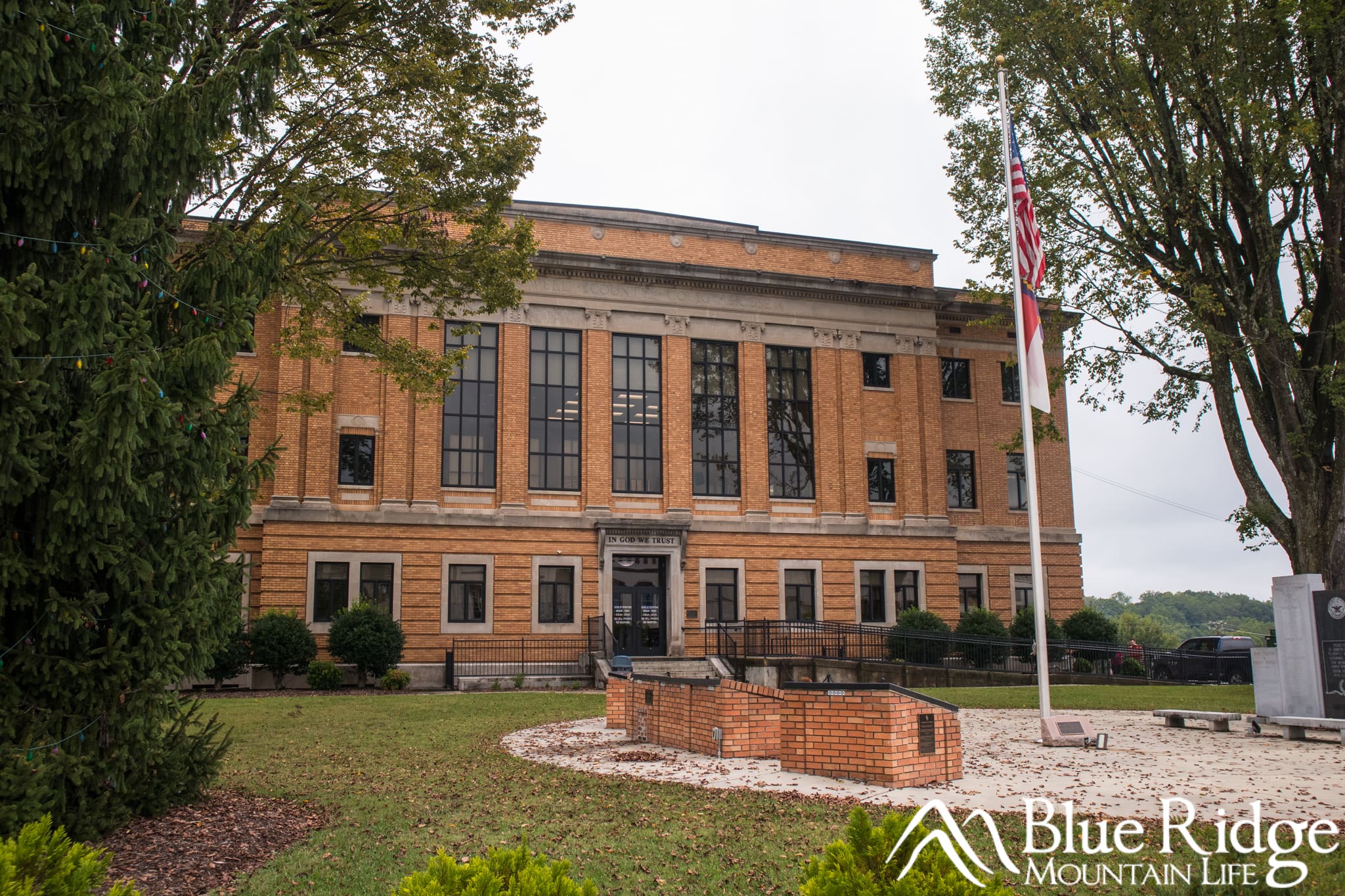Historic Marion, NC County Courthouse Historic Marion, NC County Courthouse. The building is between two large trees and made out of brown brick and stone. There are large windows on the front, with a concrete walkway to the main entrance.