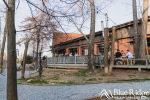 Frog Level Brewing photo, showing their back deck and outdoor seating area that is creekside.