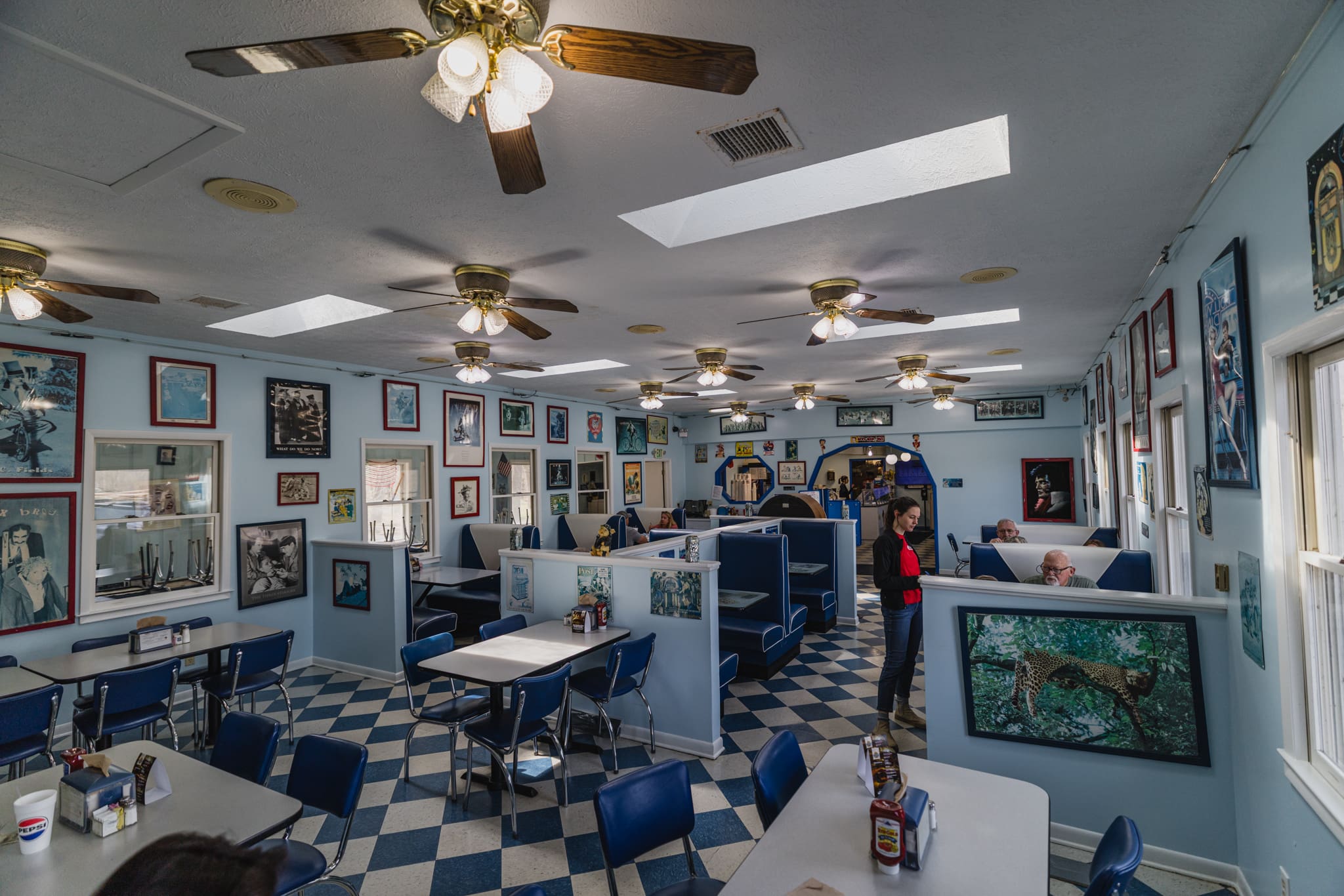 Jukebox Junction near Waynesville, NC Jukebox Junction near Waynesville, NC - Photo shows a blue and white decorated dining room, resembling a 50s diner. There are bench seats for customers to sit in, and 50s era decor covers the walls.