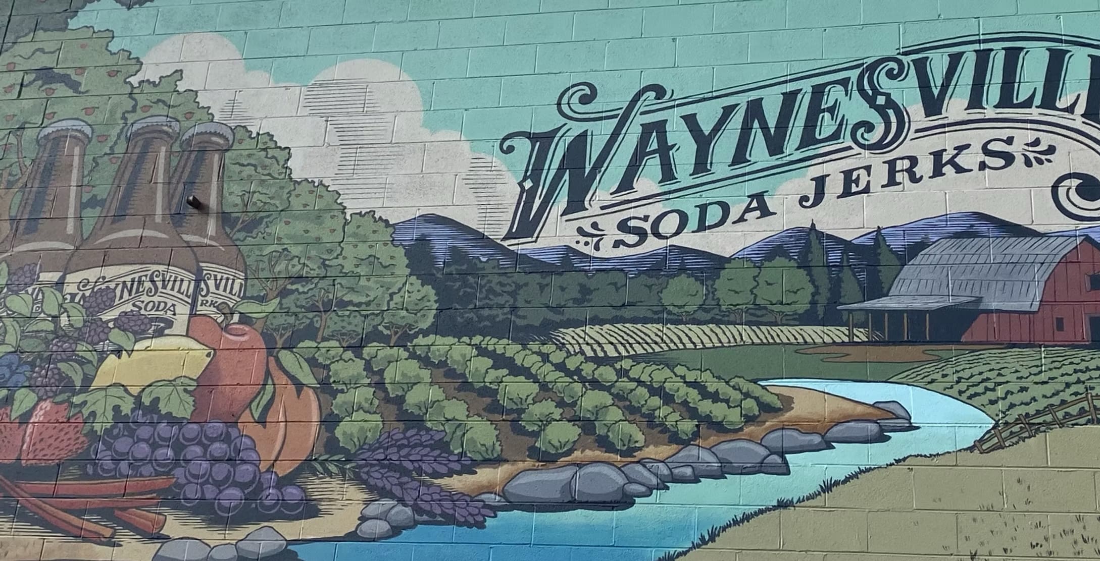 Waynesville Soda Jerks Label for Waynesville Soda Jerks bottles, show the name with fields surrounded by mountains