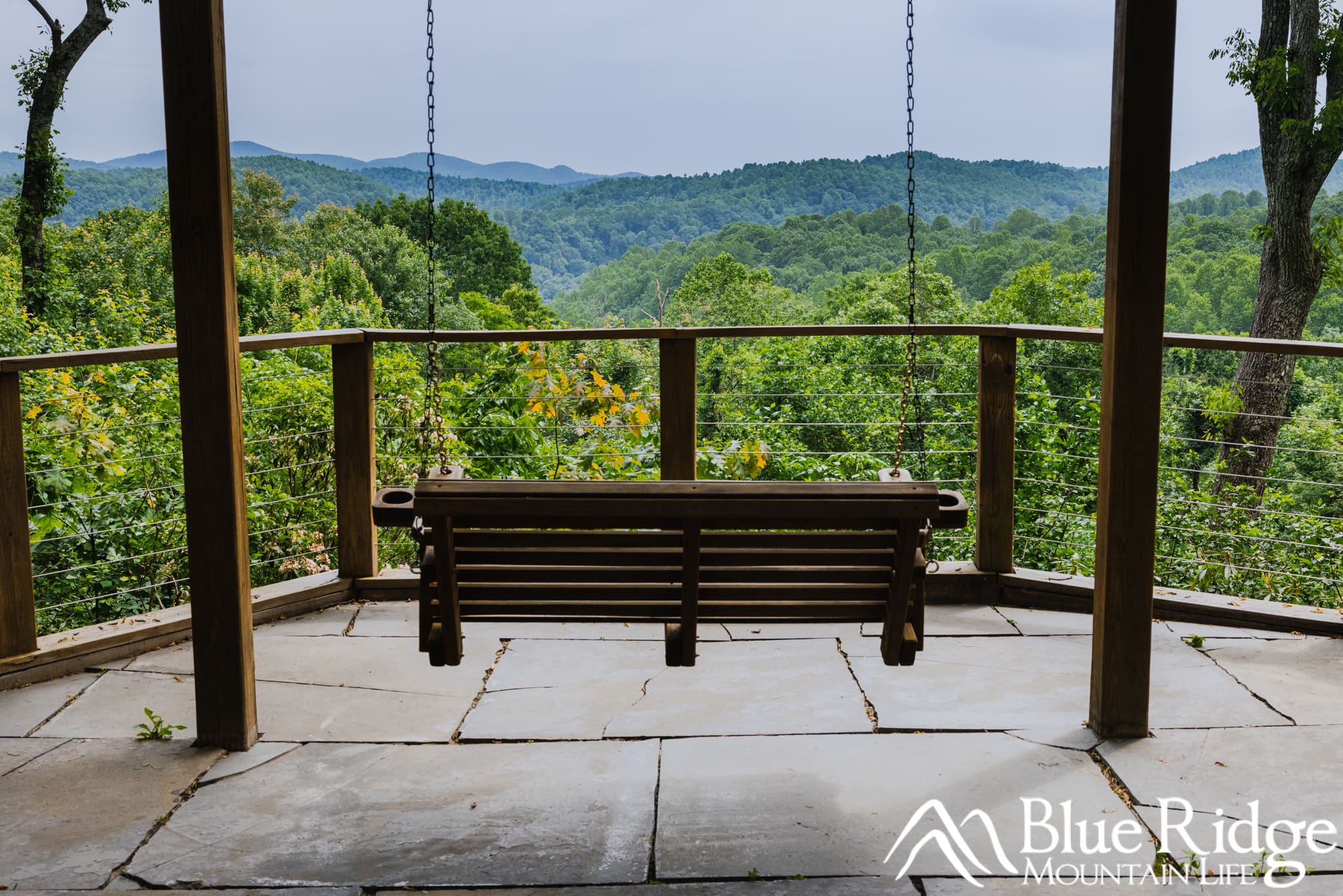 Where to Stay in Saluda NC Where to Stay in Saluda NC - Photo shows a hanging wooden porch swing facing an beautiful mountain view.